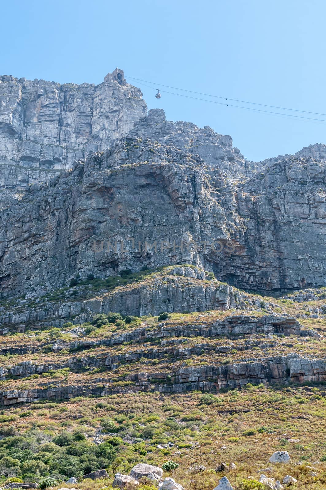 View of Table Mountain and upper cable station in Cape Town. A cable car is visible. The cableway was opened on October 4, 1929
