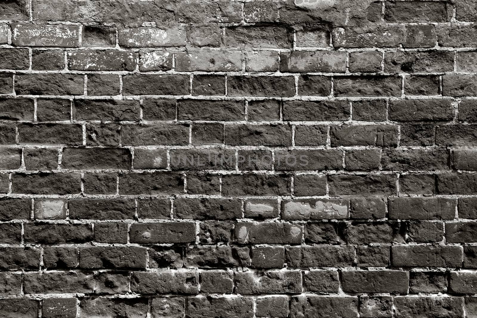 Old brick wall with dark bricks
