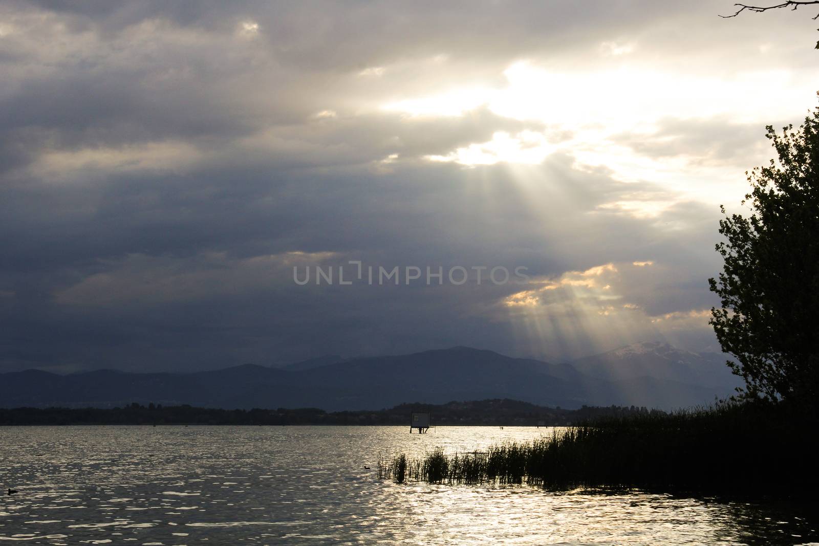 Lake Varese with the sun peeking out from the clouds