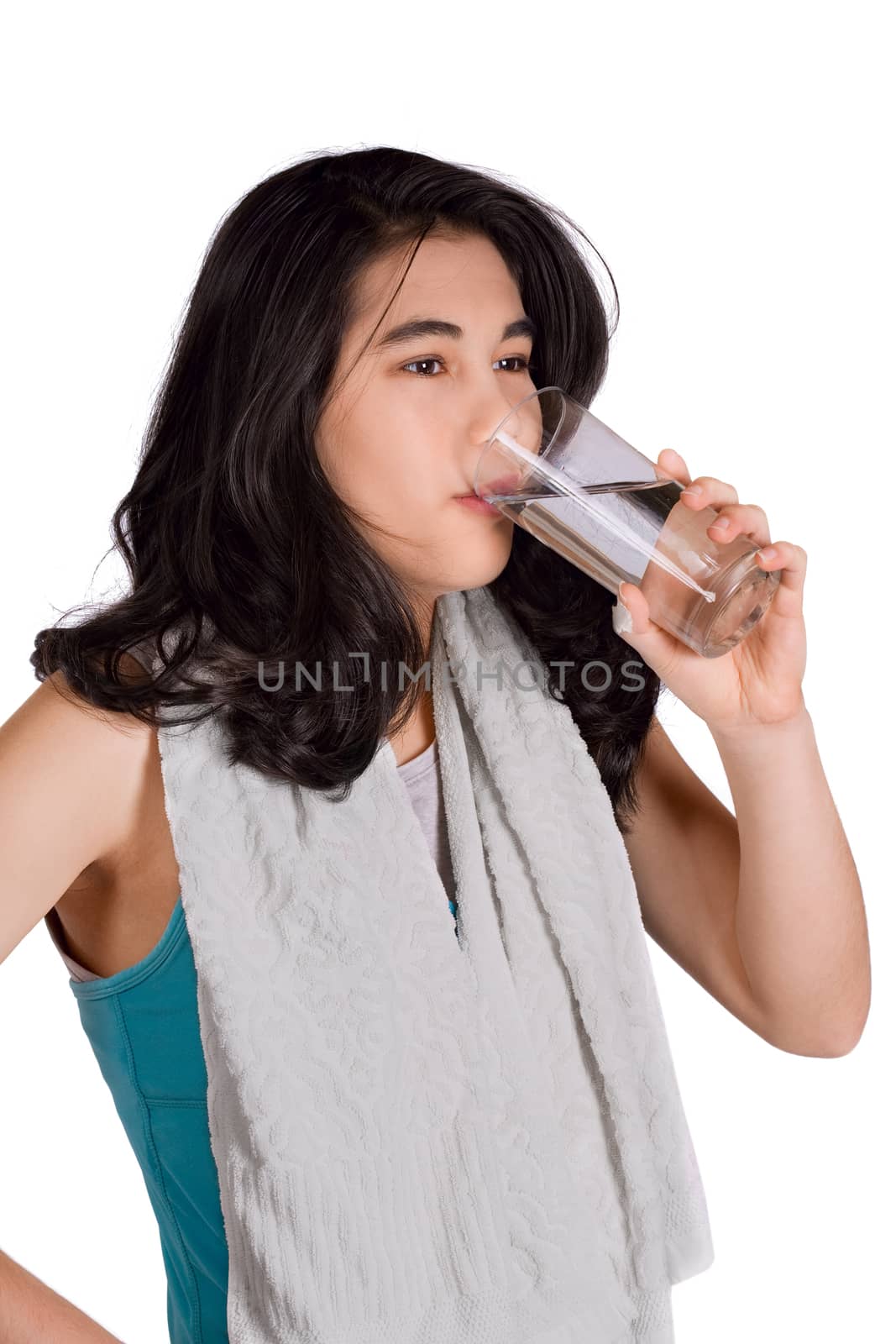 Beautiful biracial teenage girl drinking water while exercising by jarenwicklund
