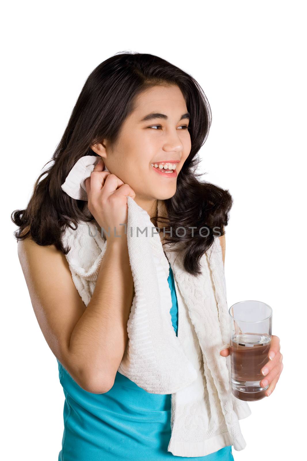 Beautiful biracial teenage girl drinking water while wiping off sweat
