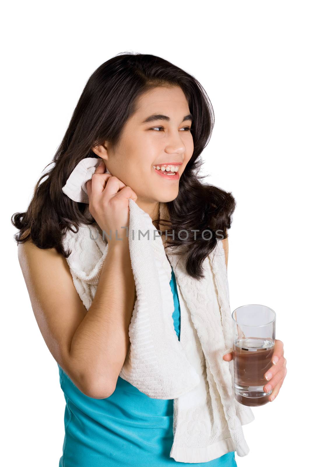 Beautiful biracial teenage girl drinking water while wiping off  by jarenwicklund