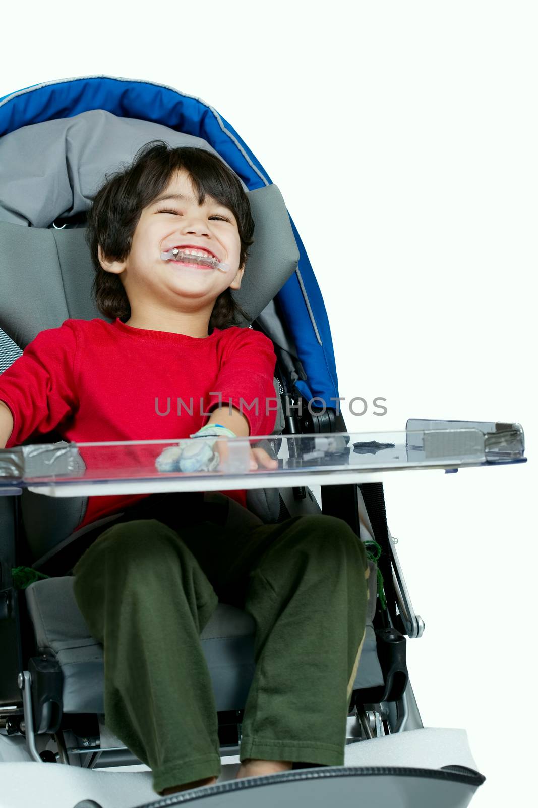 Three year old biracial disabled boy in medical stroller, happy  by jarenwicklund