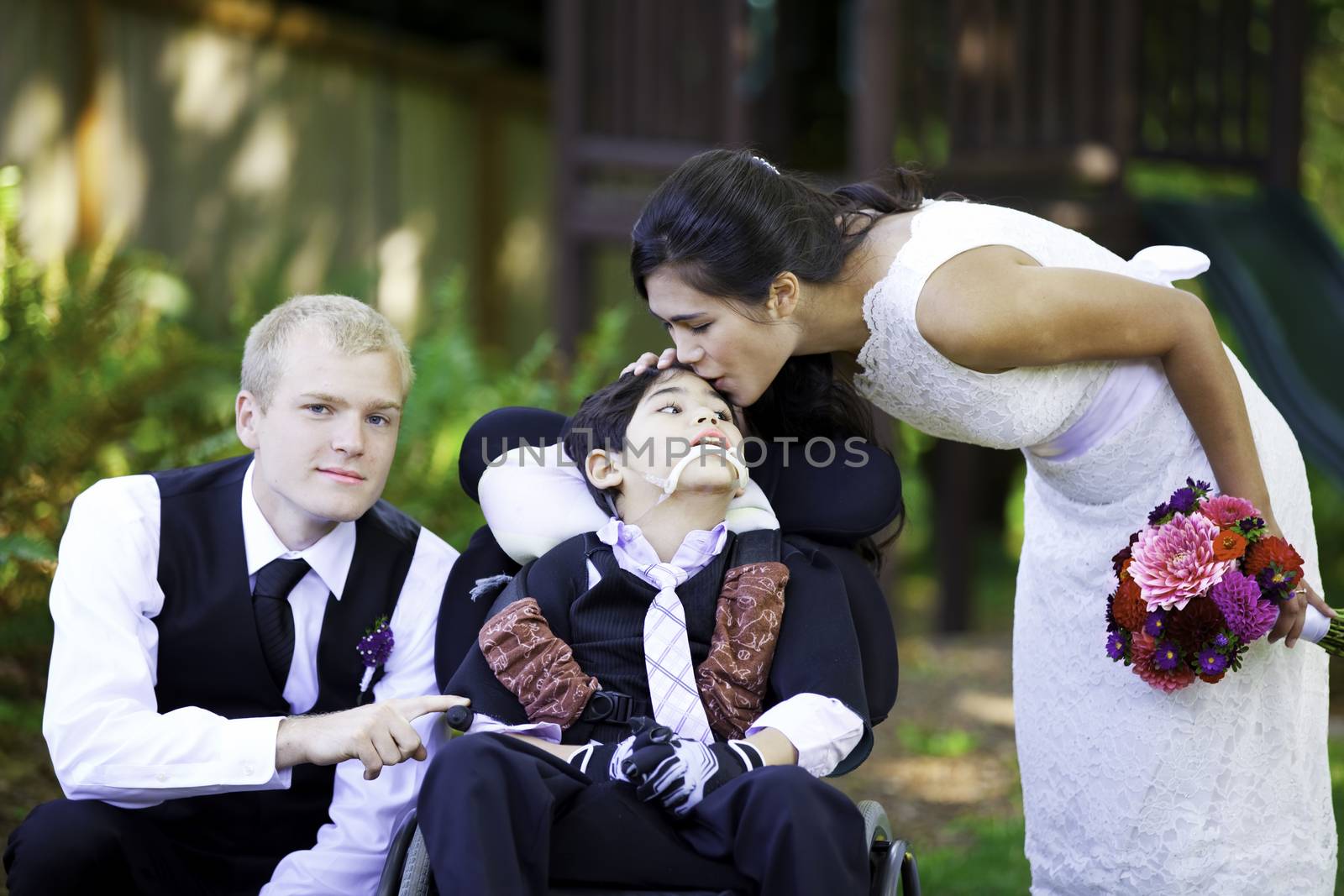 Biracial bride kissing her little brother on her wedding day. Ch by jarenwicklund