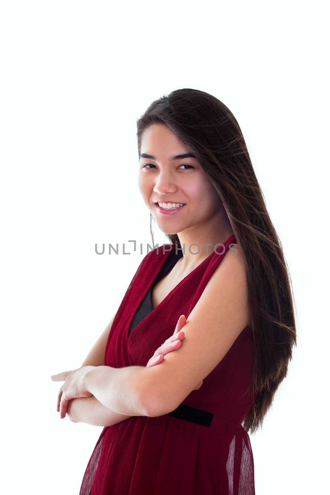 Beautiful biracial teen girl in red dress standing arms crossed, by jarenwicklund