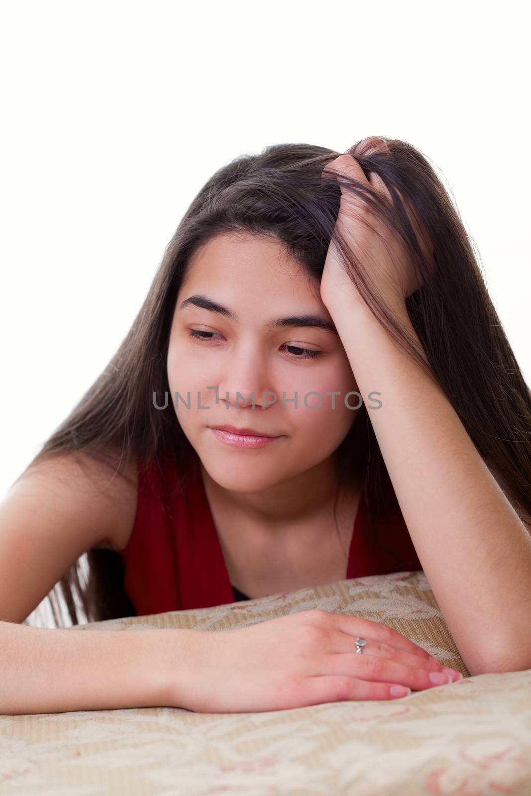 Biracial teen girl in red dress looking bored or tired, leaning head on hand