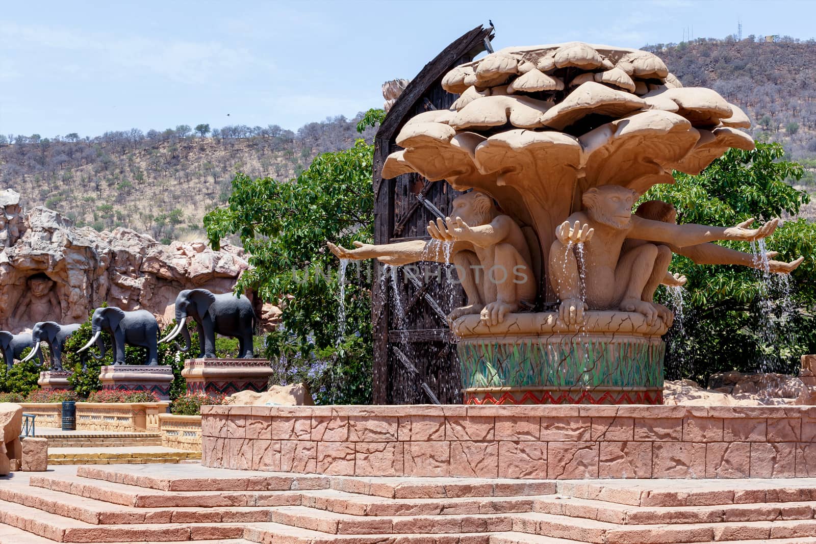 Gigantic monkey and elephant statues on fountain near bridge in famous Lost City in Sun City, South Africa.