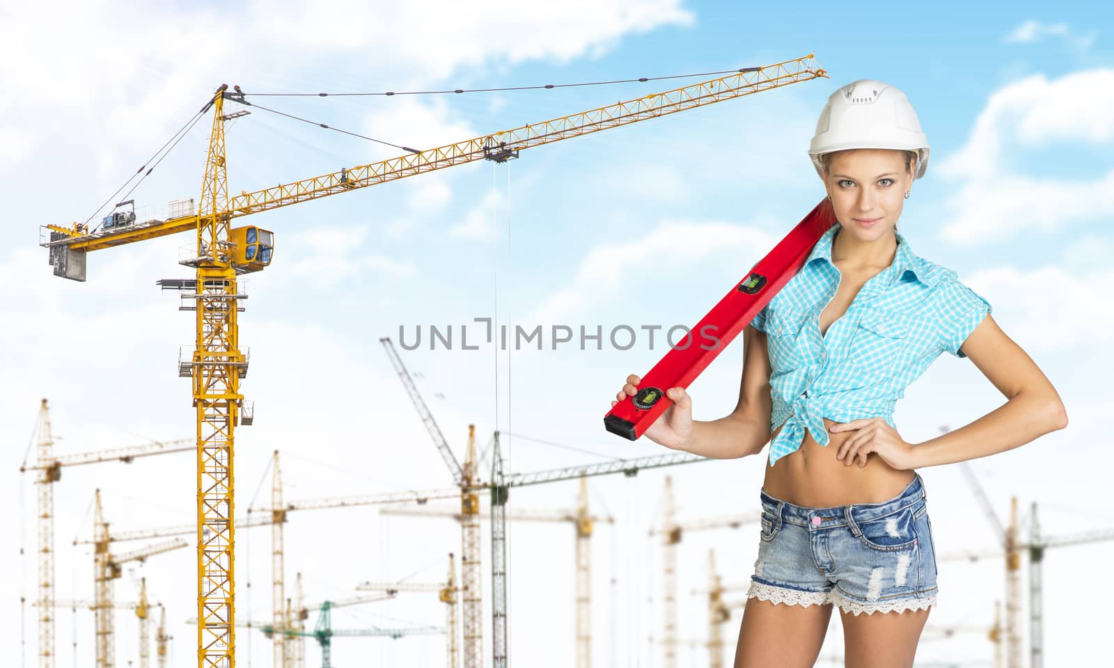 Woman in hard hat with large builders level on her shoulder by cherezoff