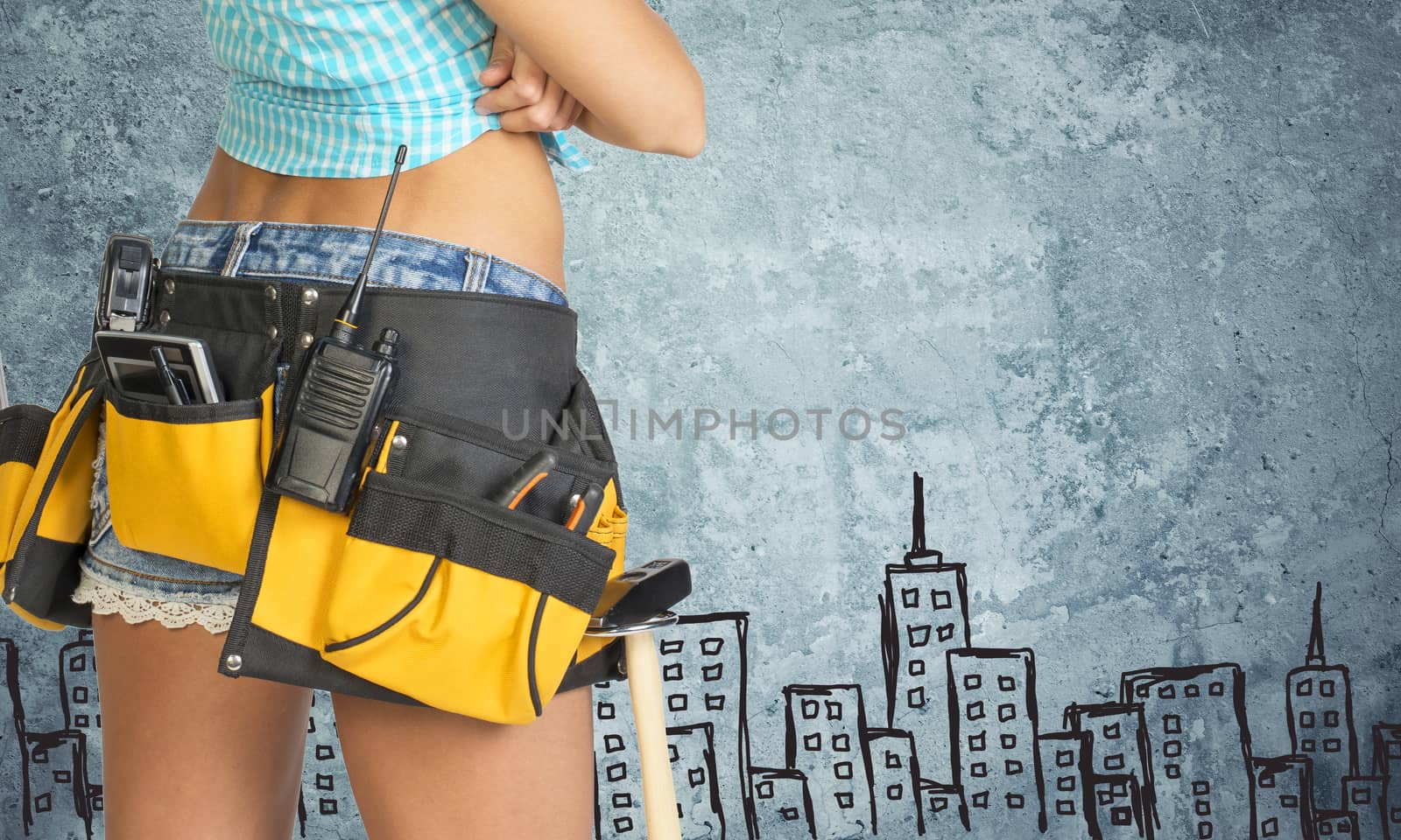 Woman in tool belt against stone wall with sketch of city on it by cherezoff