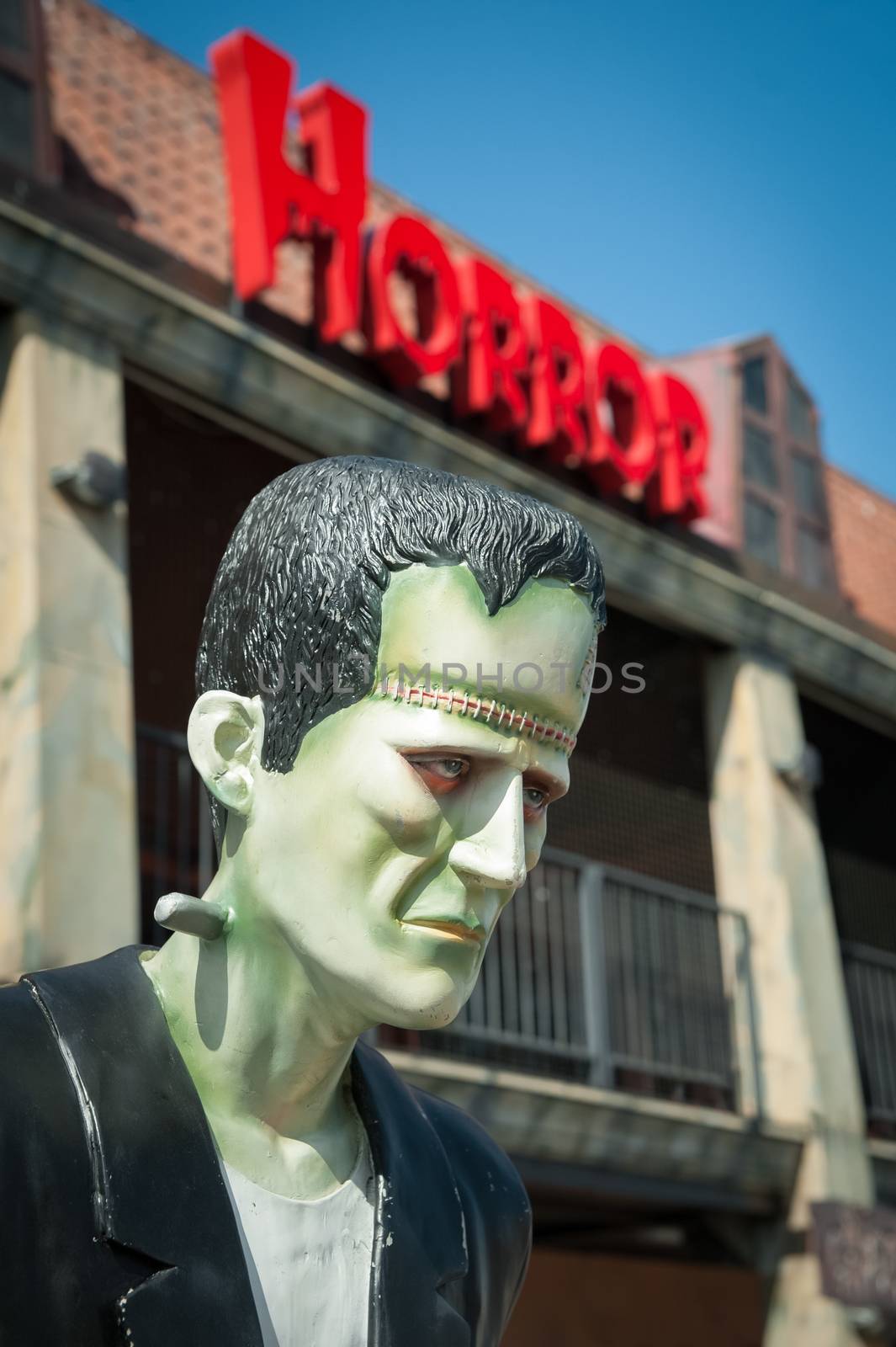 Frankenstein monster mannequin with horror sign above its head