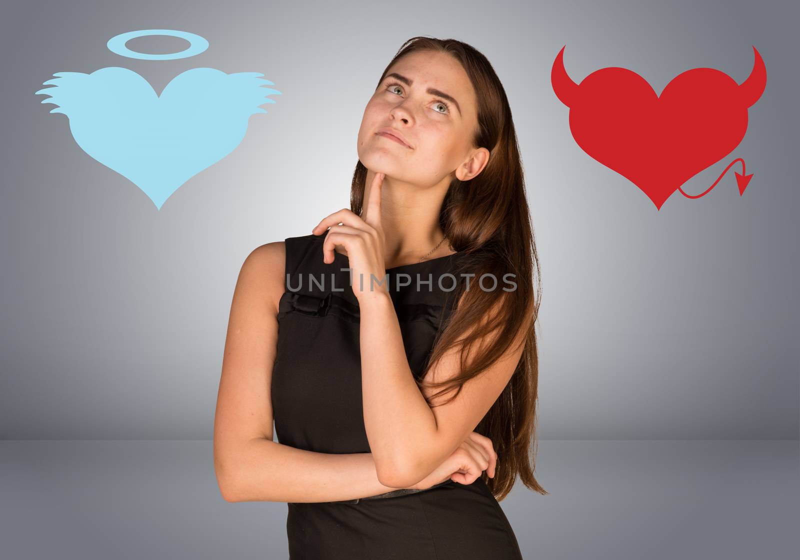 Woman musing between angel and devil hearts. On gray background