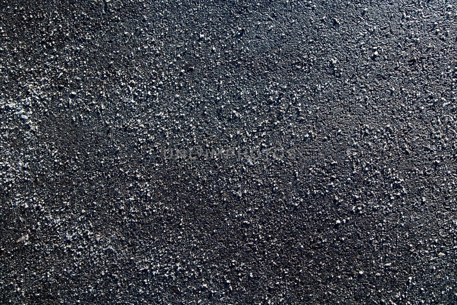 Picture of a piece of asphalt littered with salt