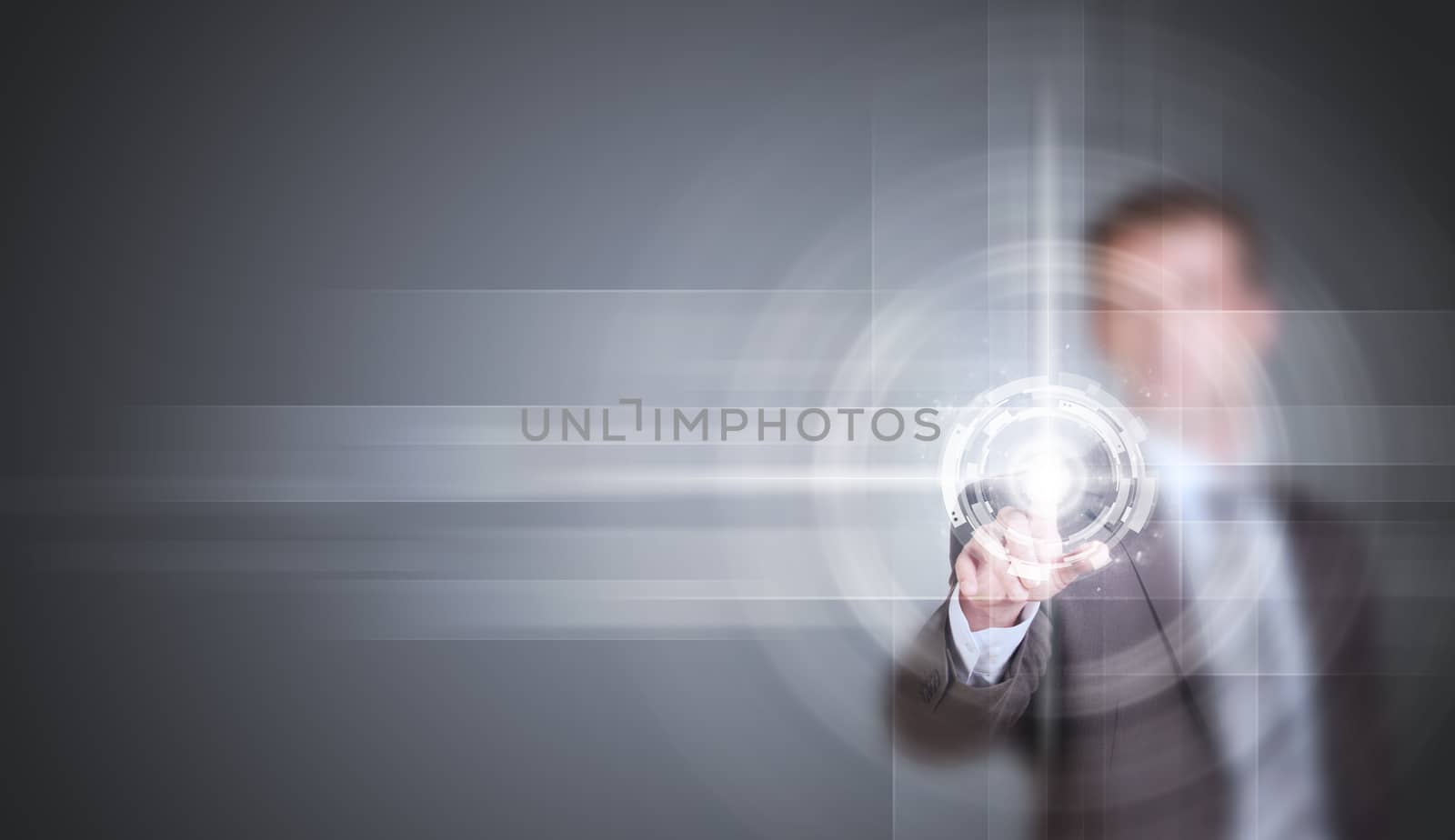 Businessman in suit finger presses virtual button. Gray gradient background