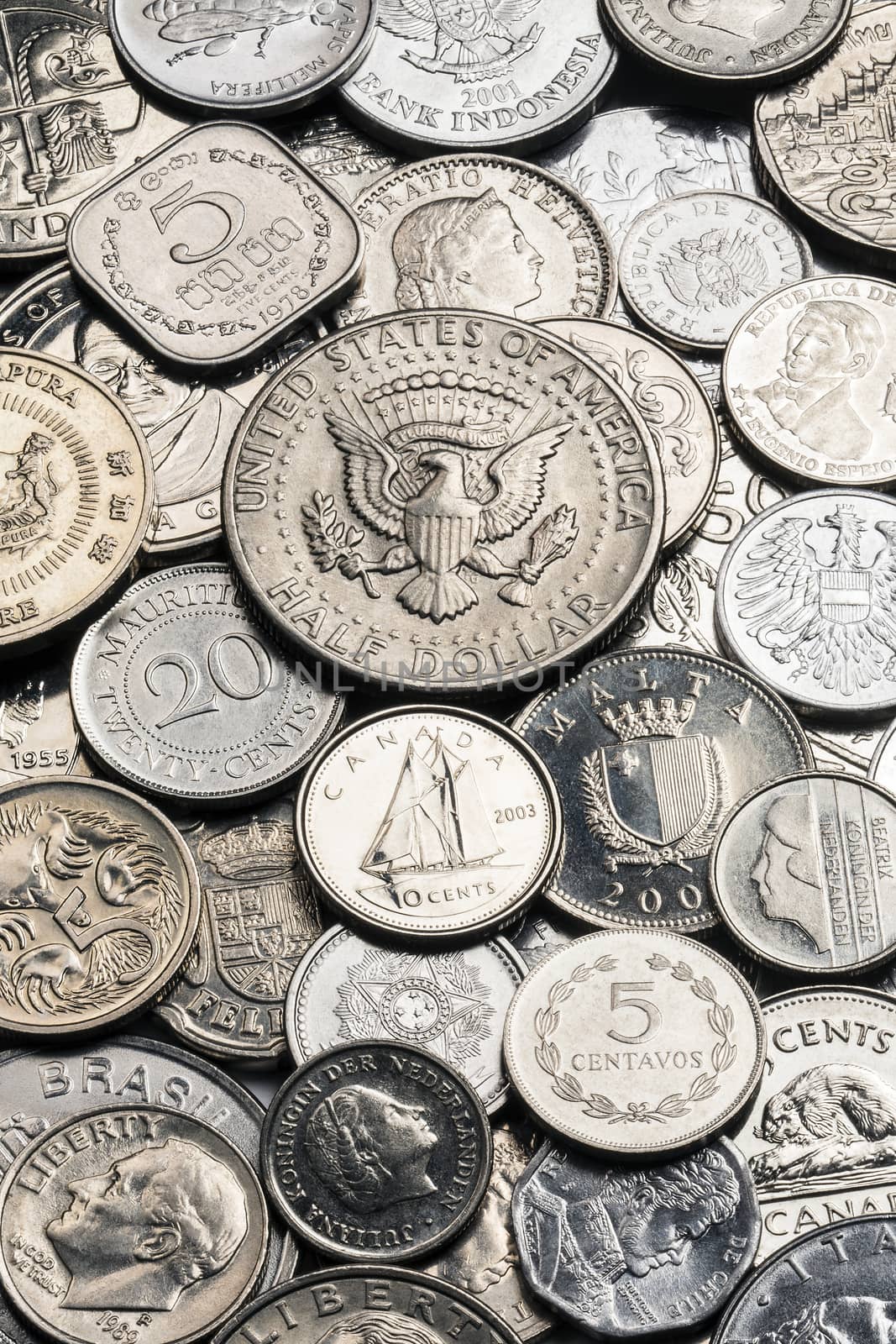A collection of old silver coins from around the world
