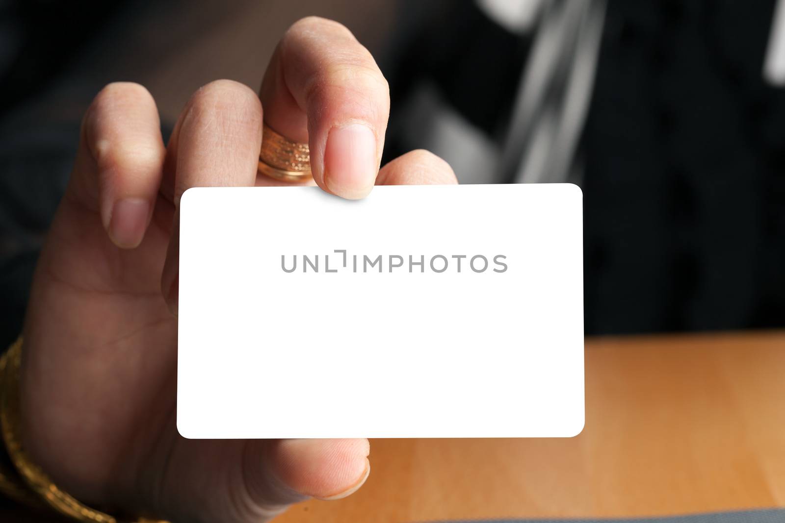 Female hand holding a blank business card gift card or credit card.  Plenty of copyspace for your logo or design.