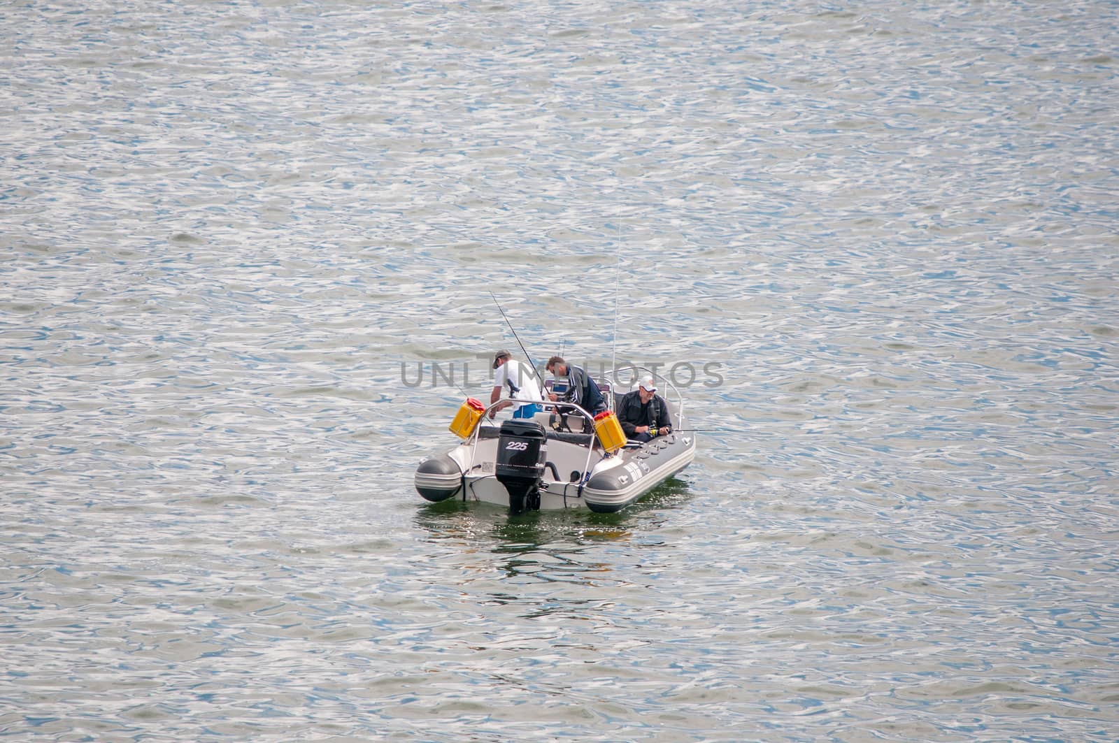CAPE TOWN, SOUTH AFRICA - DECEMBER 20TH, 2014: A boat with unidentified anglers in the sea at Gordons Bay near Cape Town. It is a favorite fishing area for tourists
