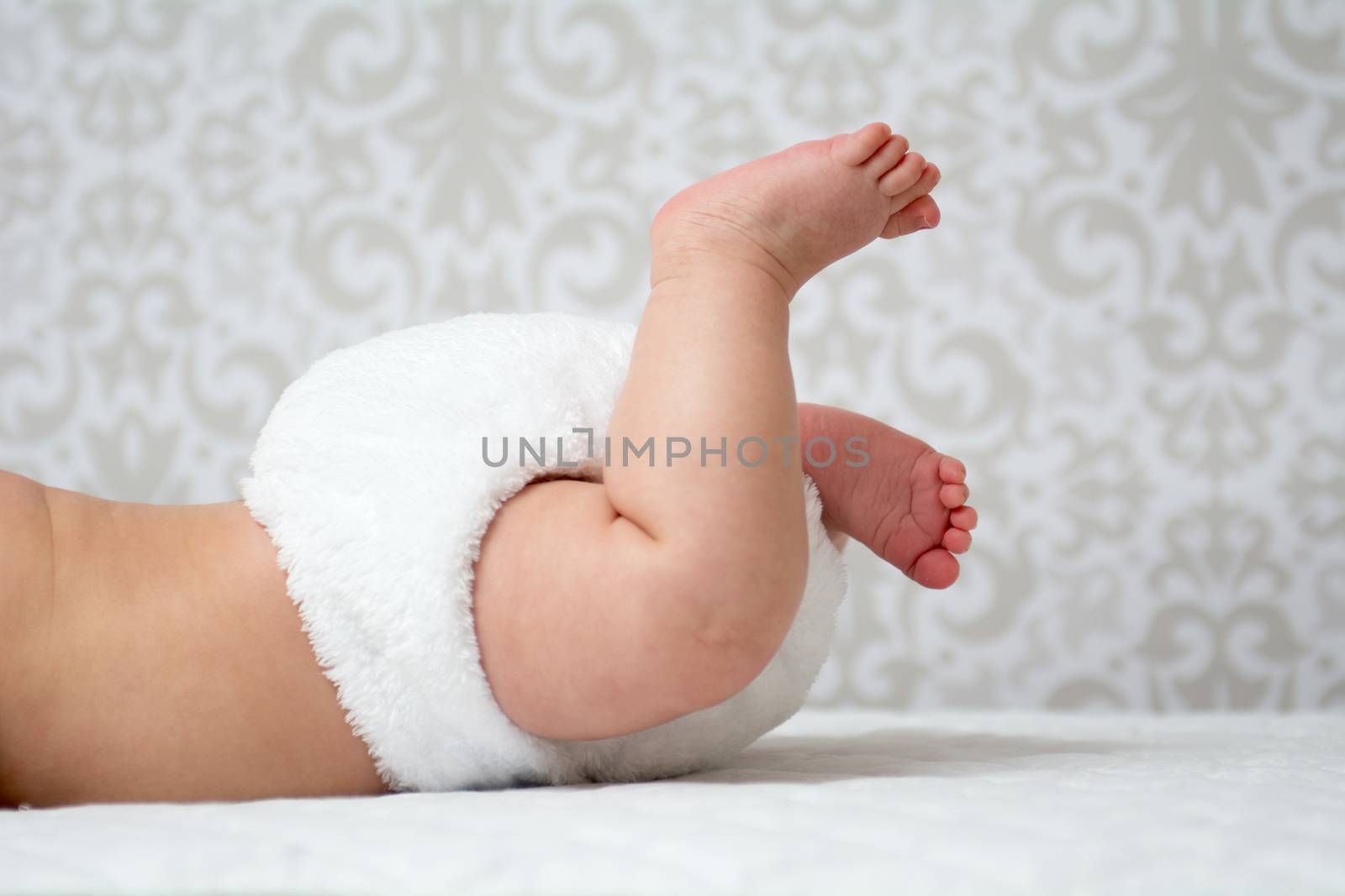Baby wearing a white reusable nappy