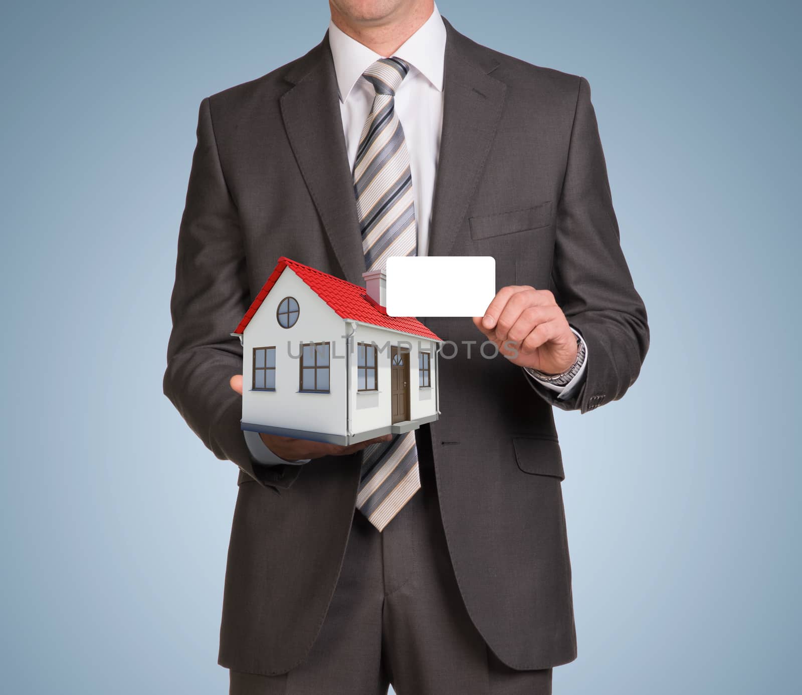 Businessman in suit hold empty card and small house by cherezoff