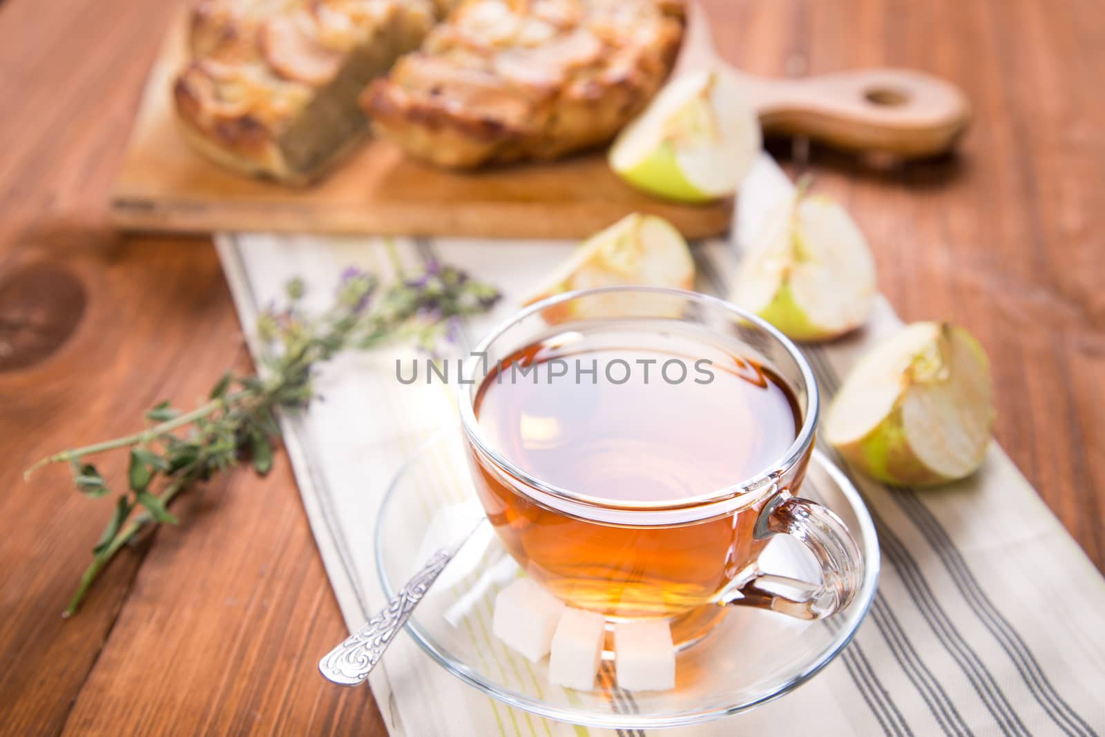 apple pie, with an cut piece and cup of tea
