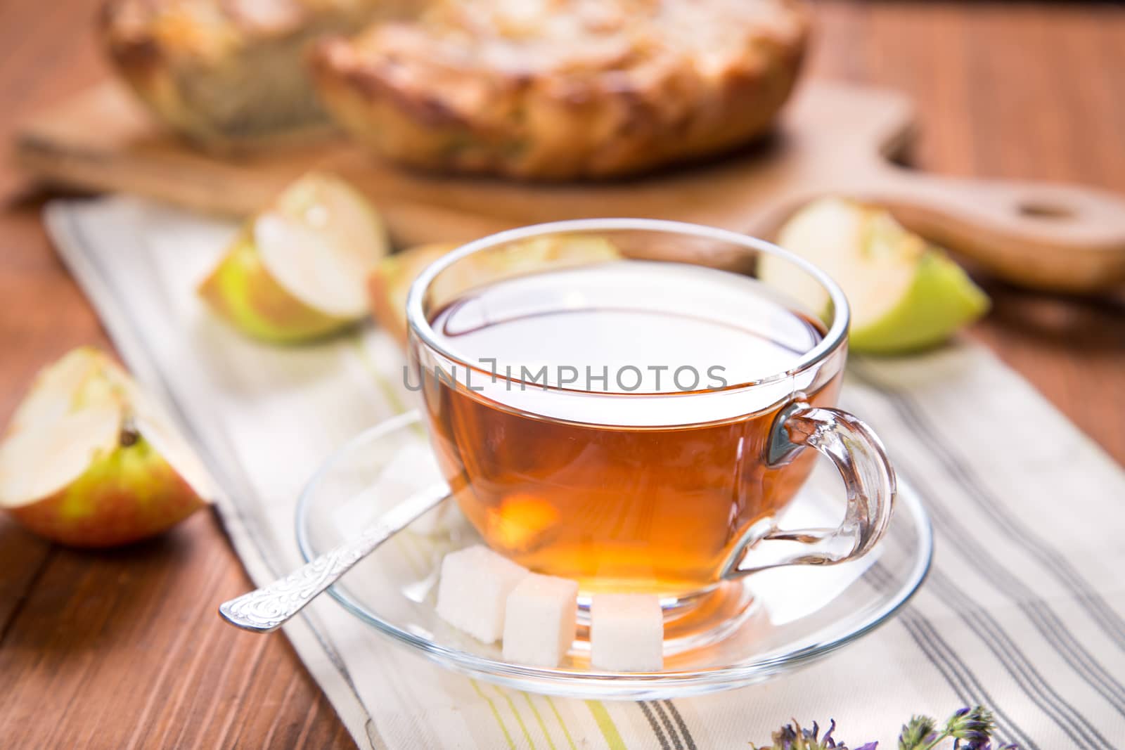 apple pie, with an cut piece and cup of tea