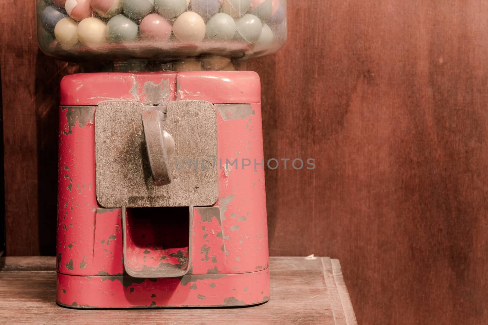 close-up ancient Gumball Machine with copyspace on the right, vintage background