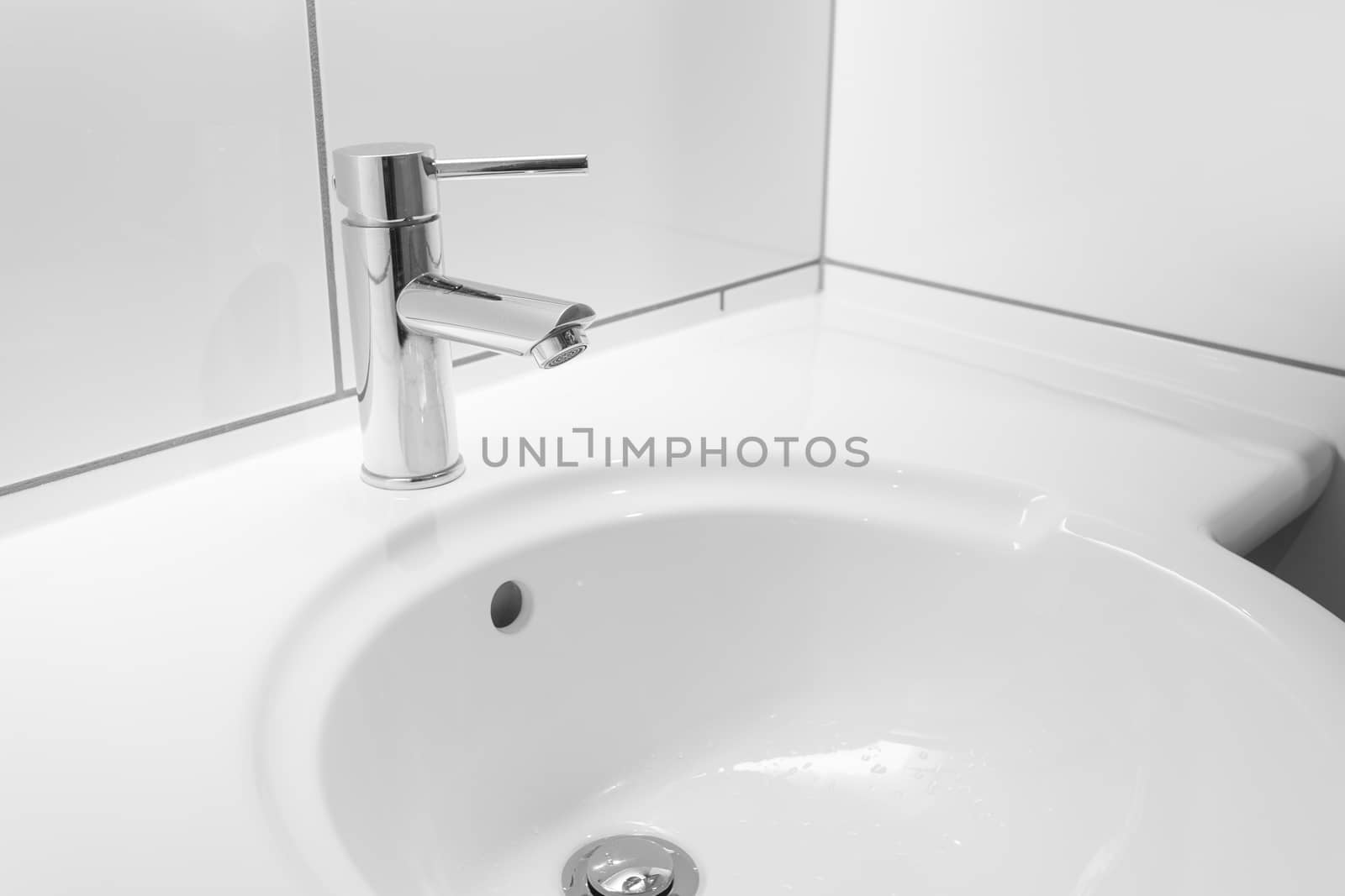 Faucet and white basin in a hotel bathroom