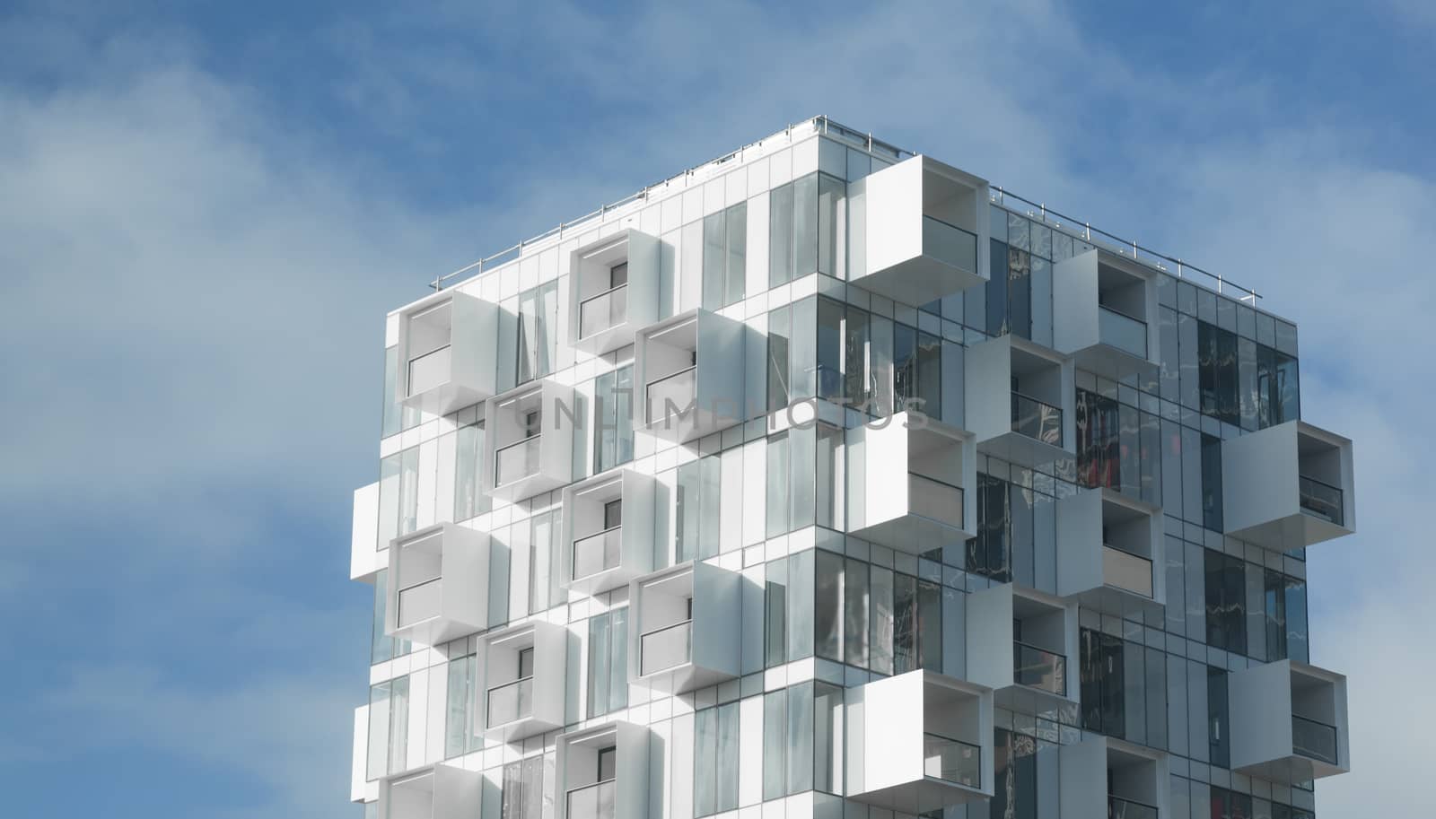 White abstract background of a modern apartment building with balconies