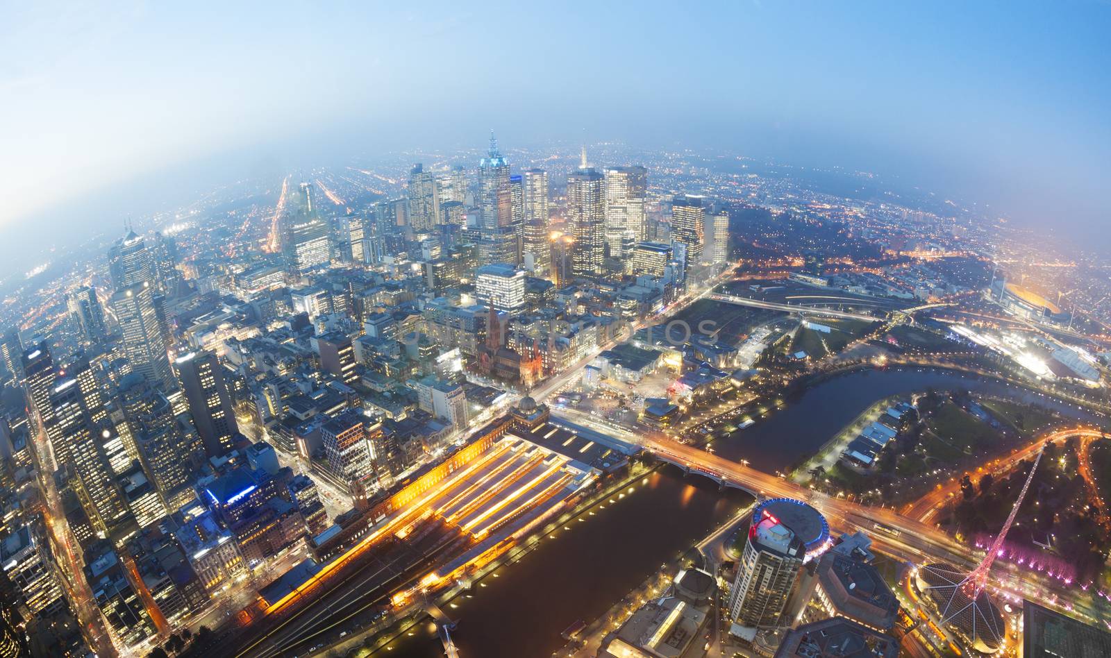 View of Melbourne CBD at twilight with major landmarks in the city including the Flinders Street railway station Melbourne Cricket Ground MCG and Federation Square