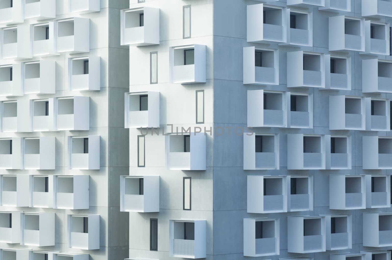 White abstract background of a modern apartment building with balconies