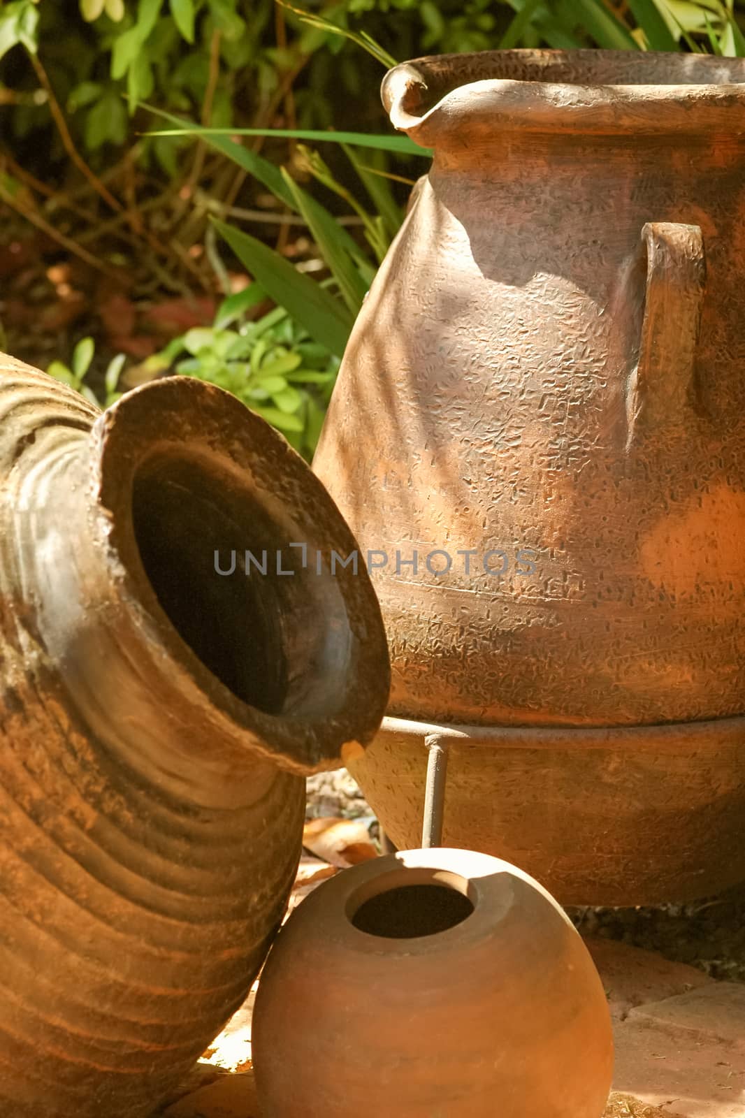 terracotta water pitcher and pots in sunshine