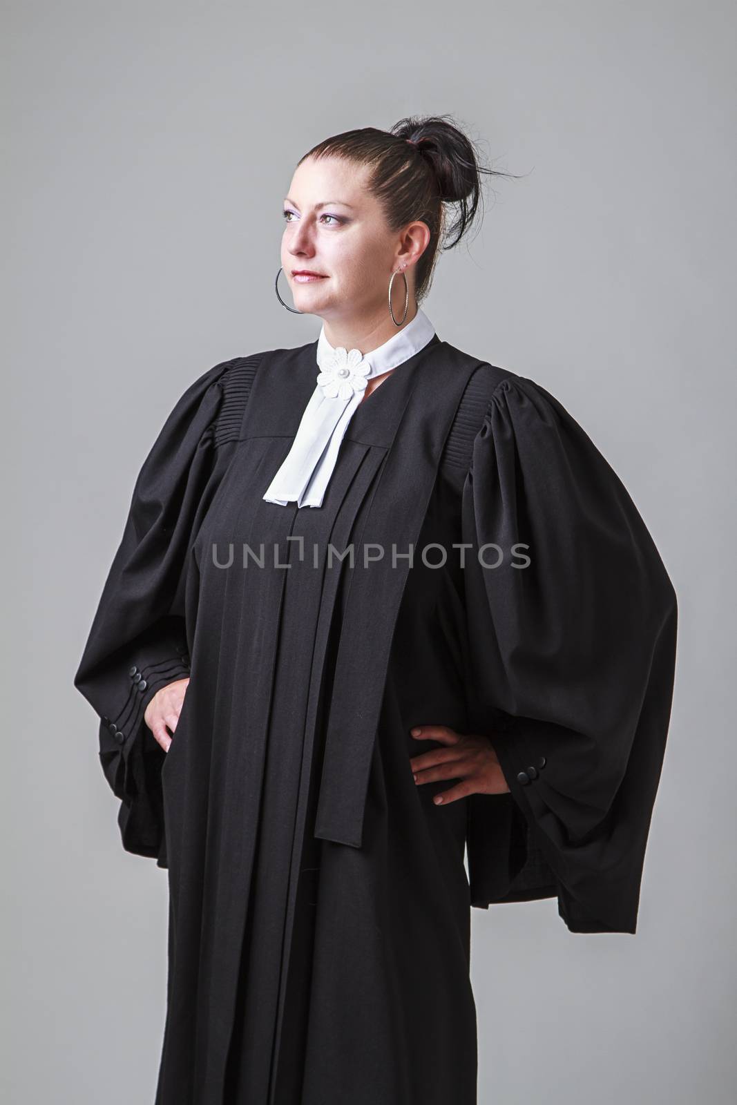 woman in her thirties, wearing a black toga canadian lawyer toga, looking to the left