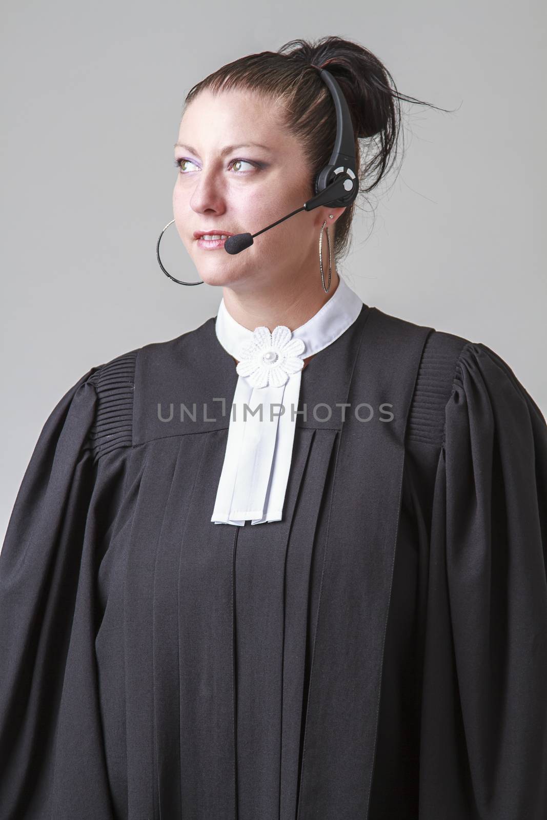 thirty caucasian woman wearing canadian lawyer toga and a wireless headset