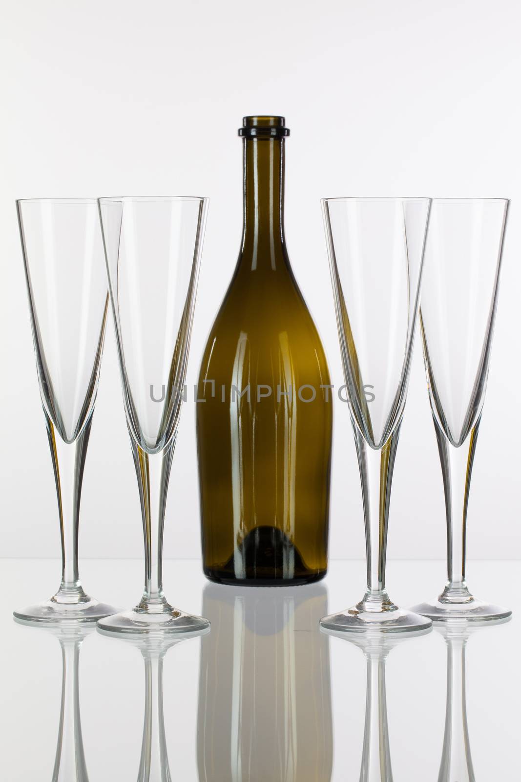 Four  champagne glasses on a glass table by CaptureLight