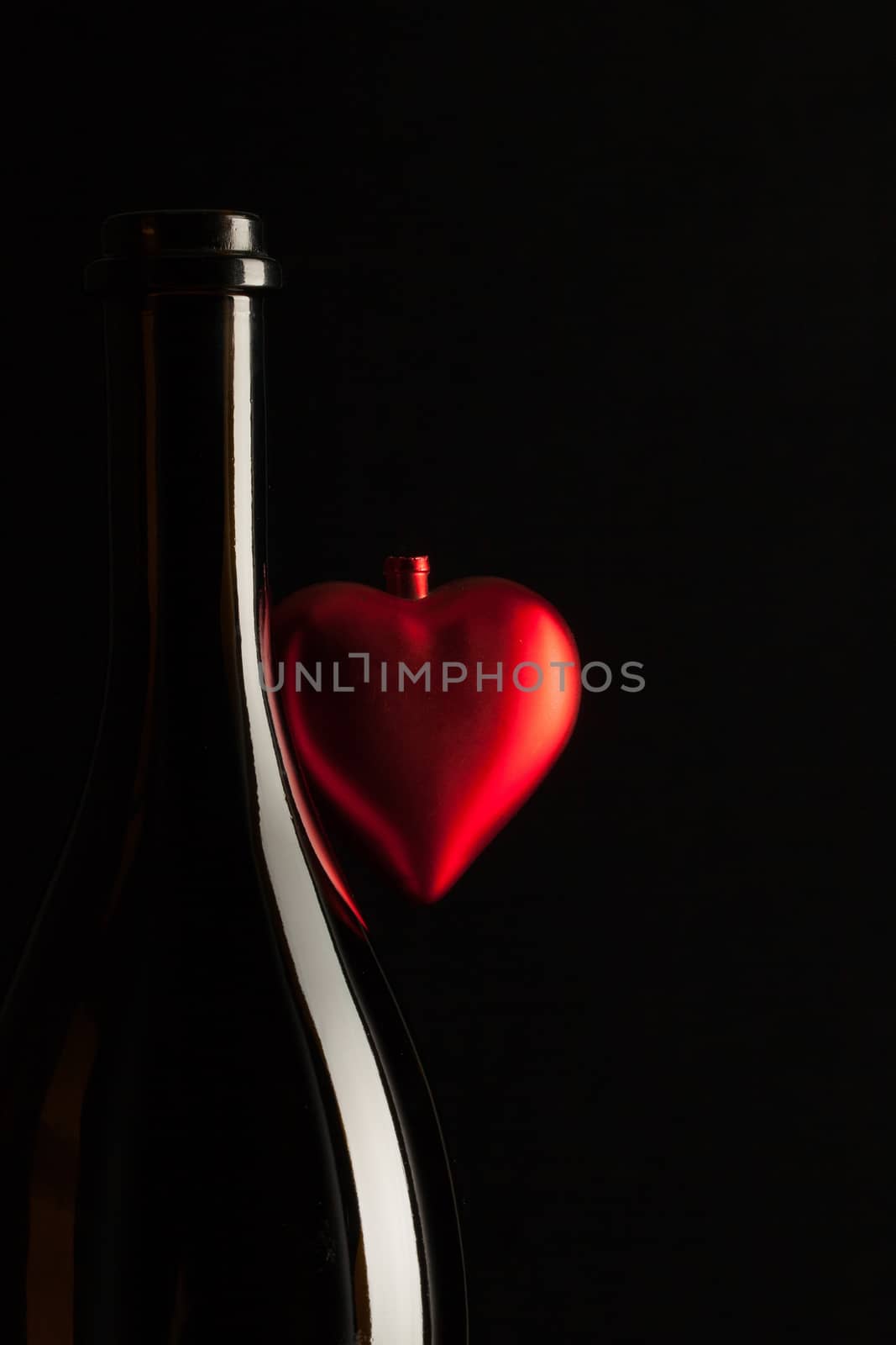 Silhouettes of elegant wine bottles with red heart  by CaptureLight