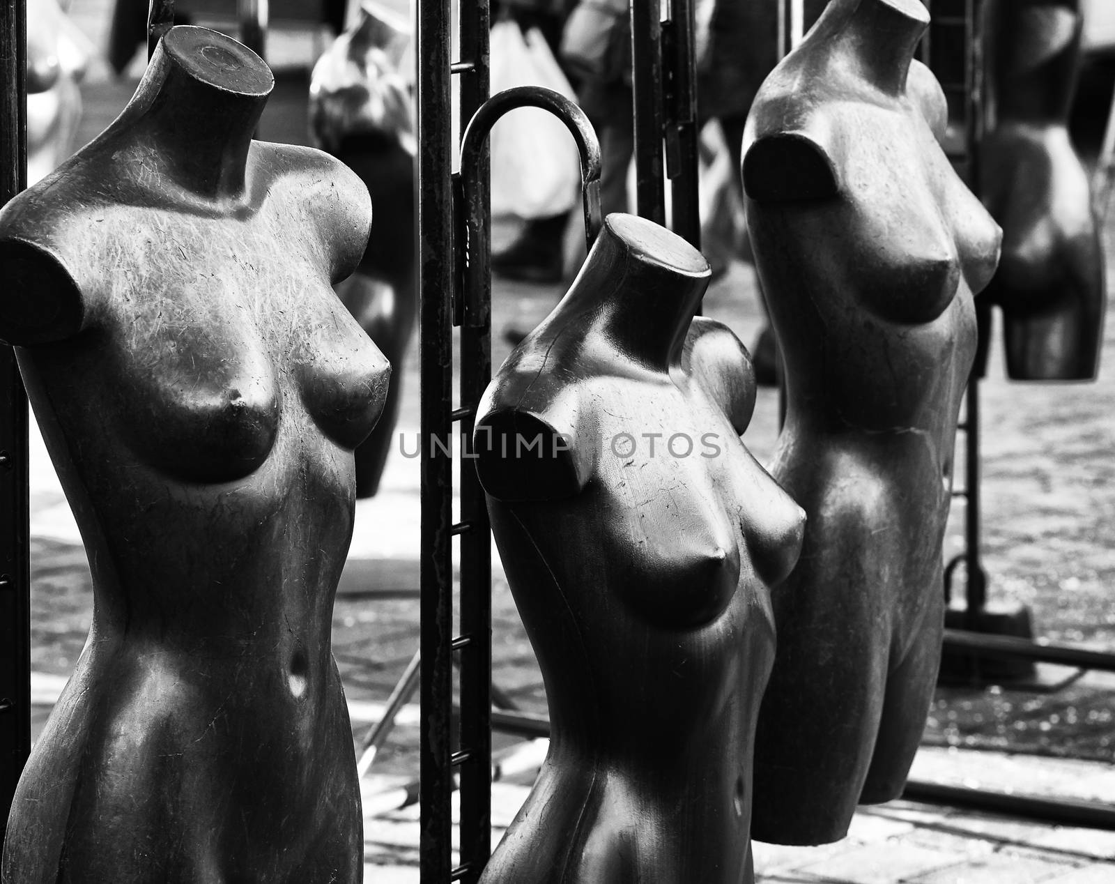 Black and White image of naked mannequins in shop window