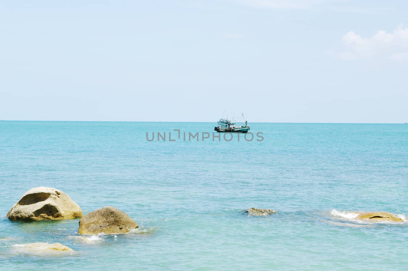 Tropical marine landscape with stones and ship on horizon. Koh Samui, Thailand.