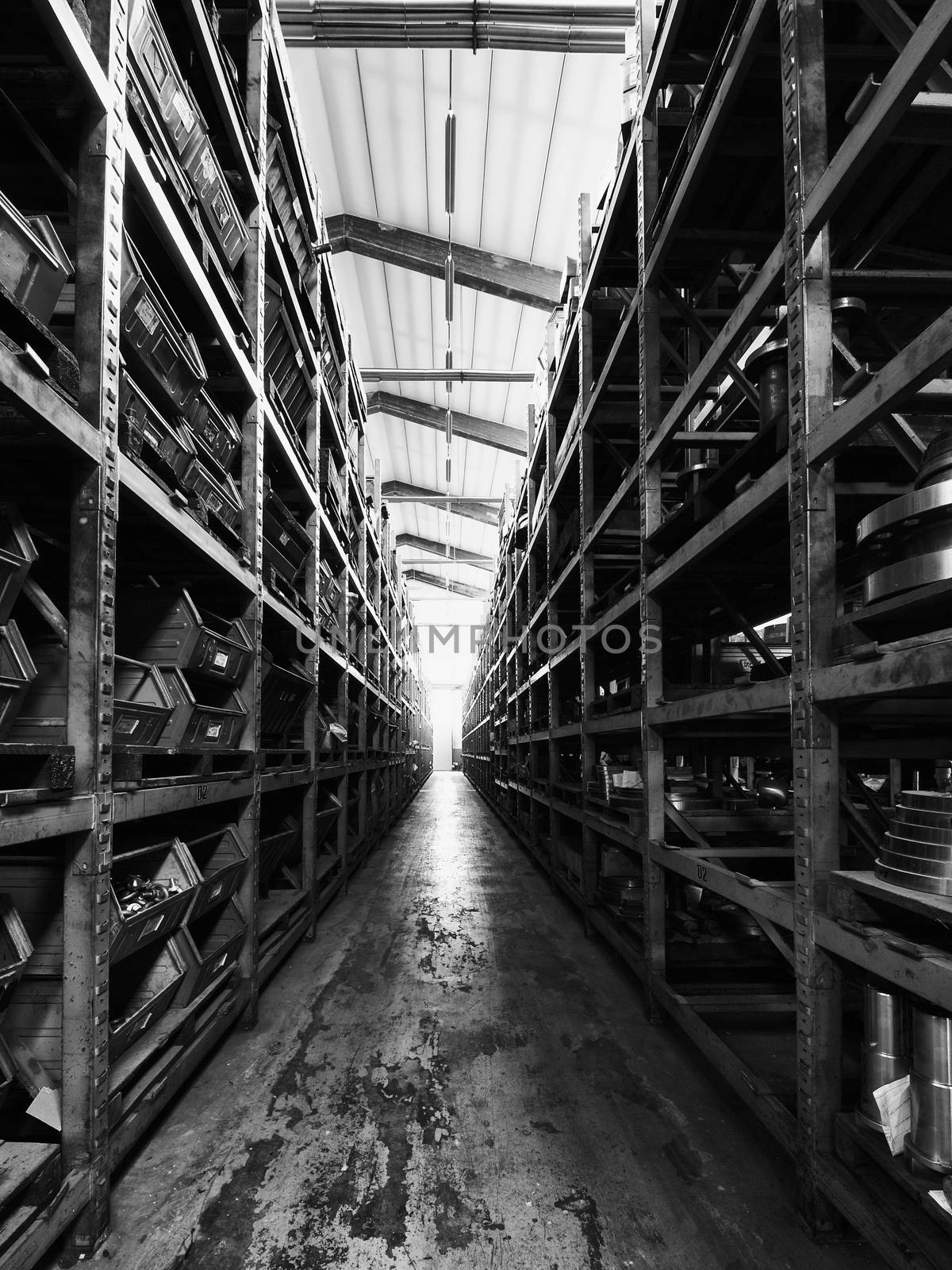 Black and White image of warehouse shelves with tools