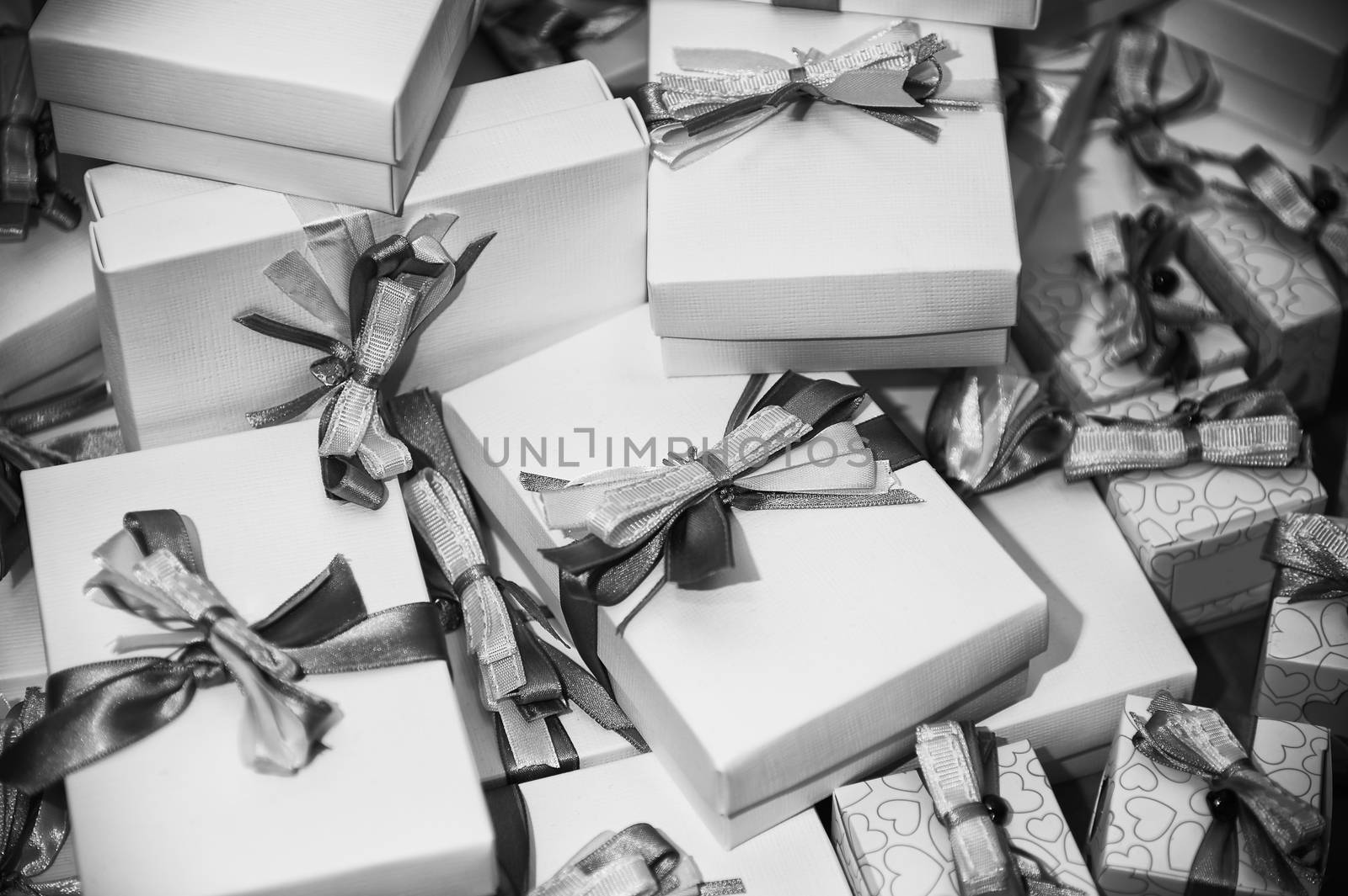 Black and white image of gifts pile with ribbons