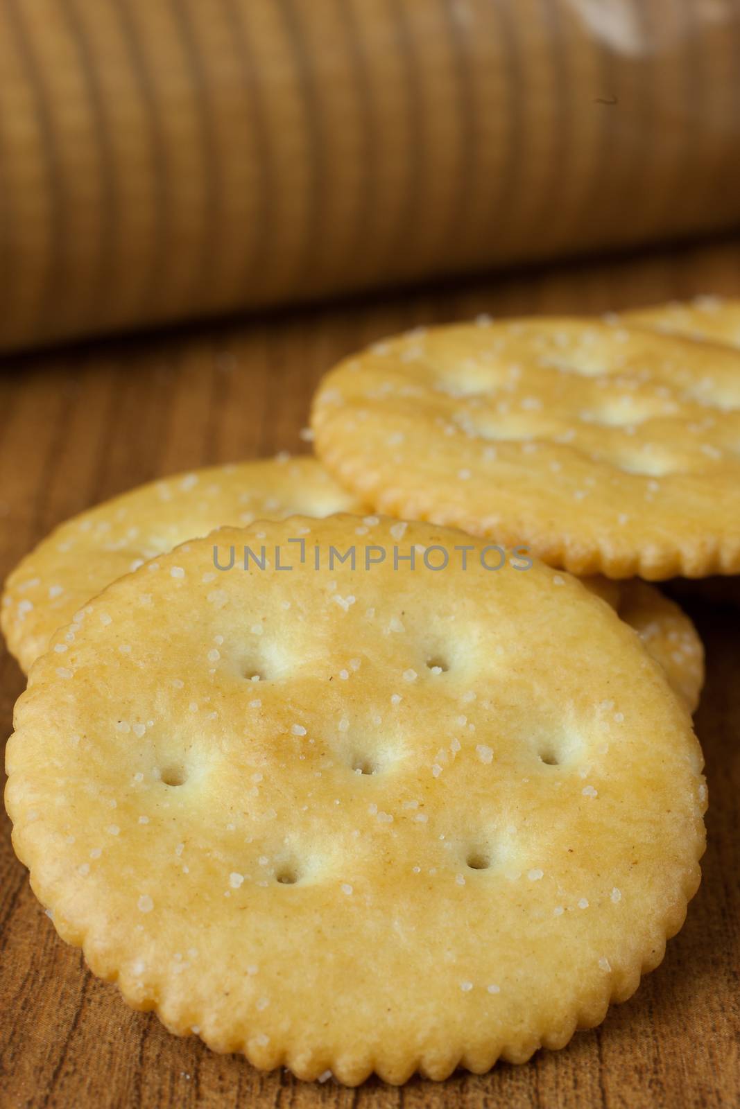 Round butter cfrackers on a wooden table or countertop.