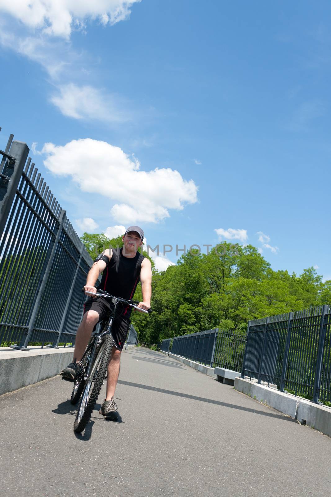 Young athletic male riding a mountain bike outdoors for exercise.