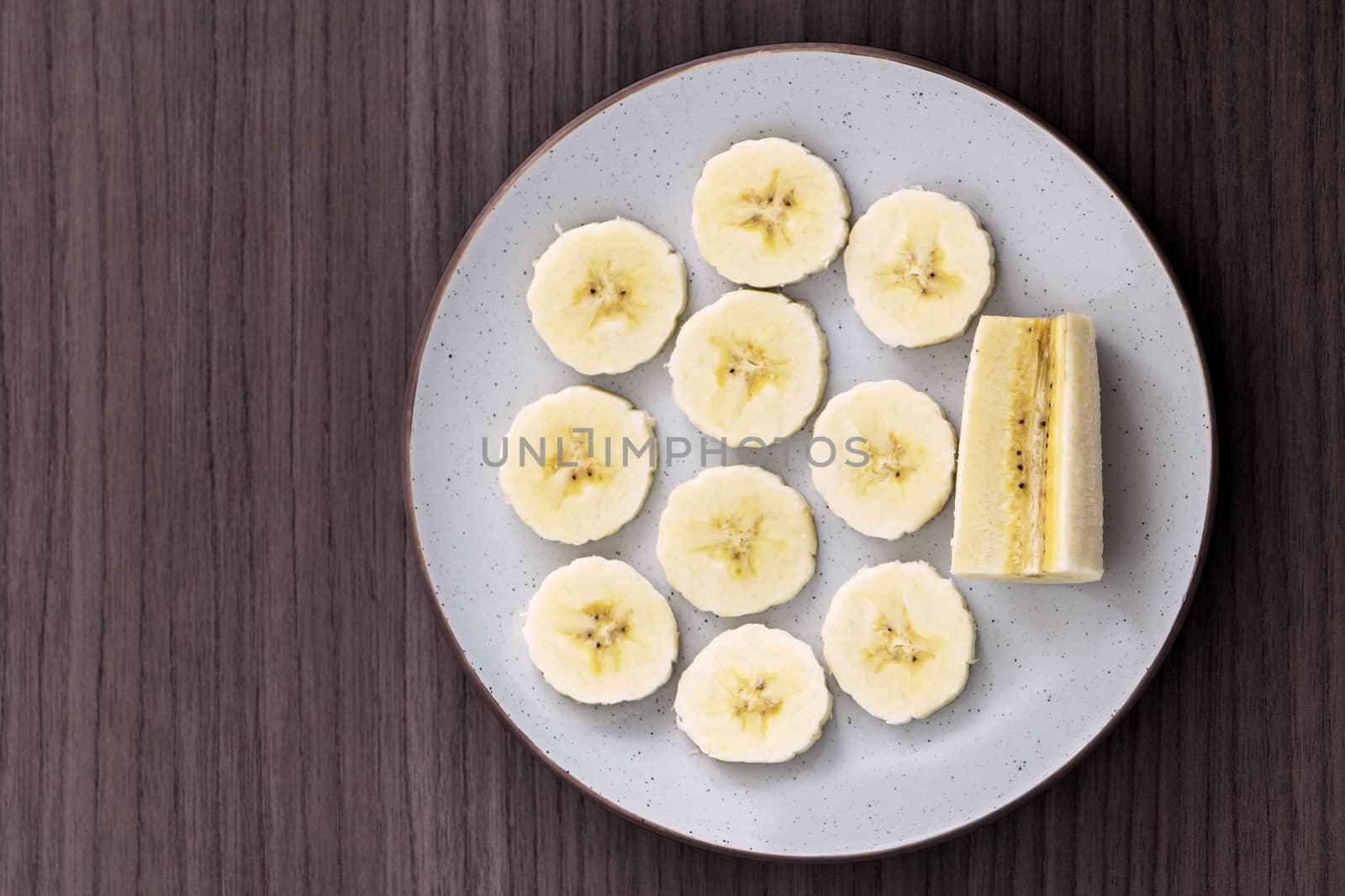 Delicious sliced banana in a dish over a table