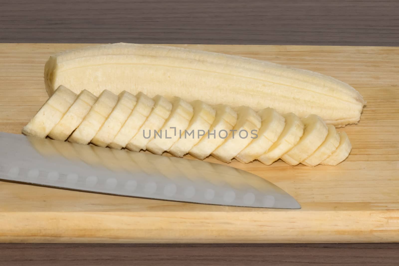 Delicious sliced banana in a dish over a table