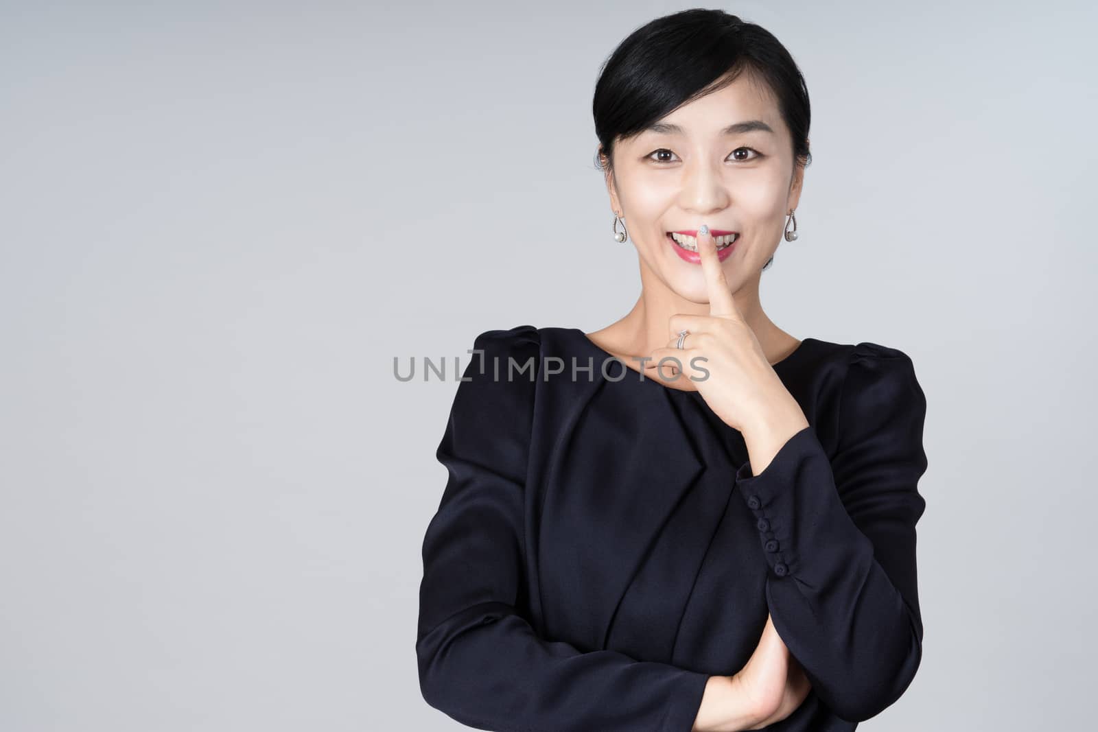 An attractive Asian woman grey background Studio images