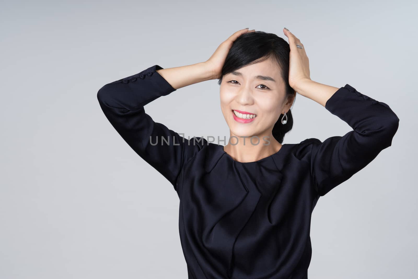 An attractive Asian woman grey background Studio images