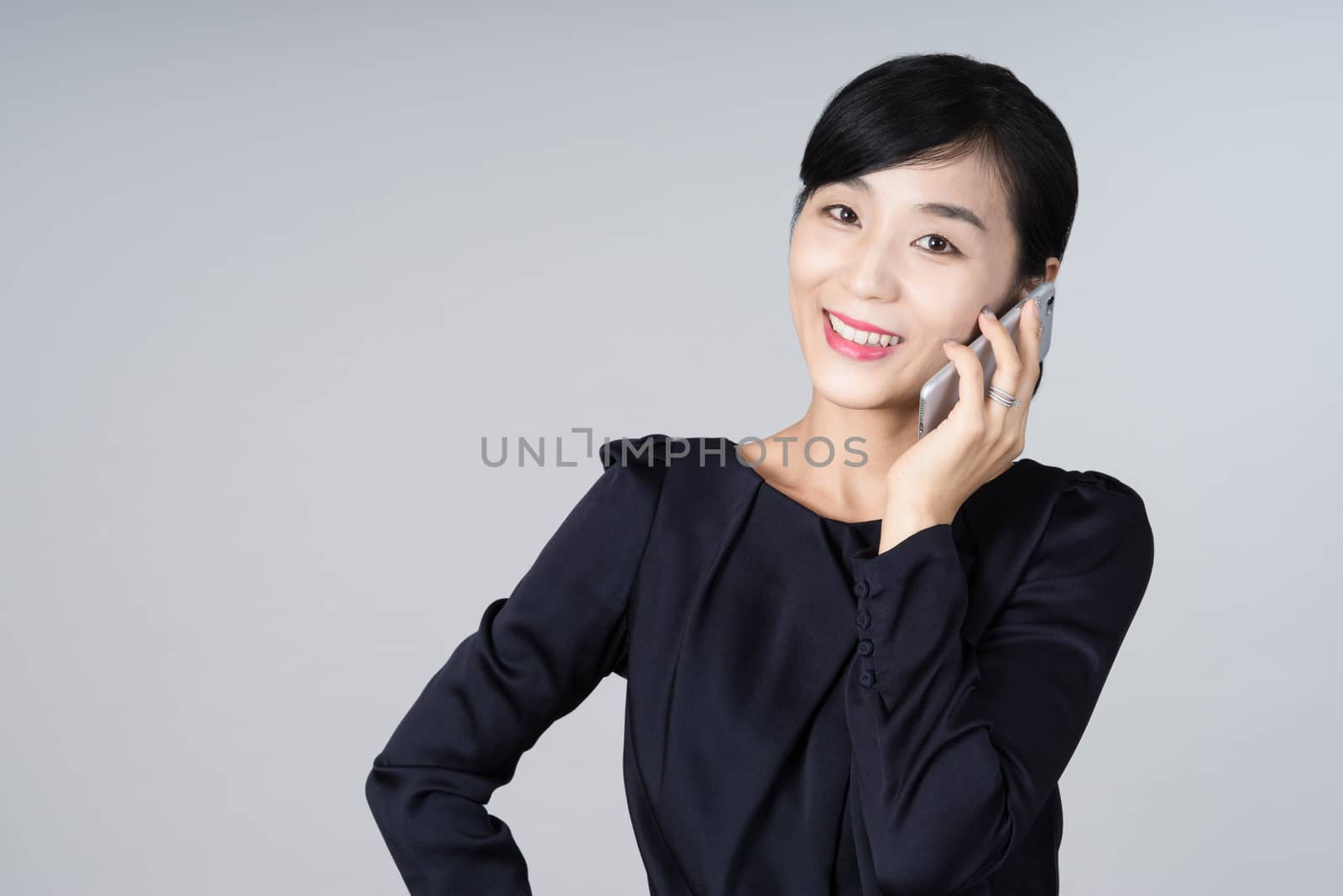 An attractive Asian woman grey background Studio images