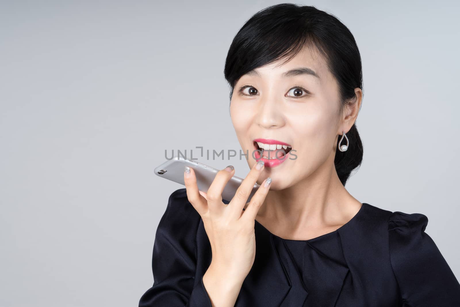 An attractive Asian woman grey background Studio images