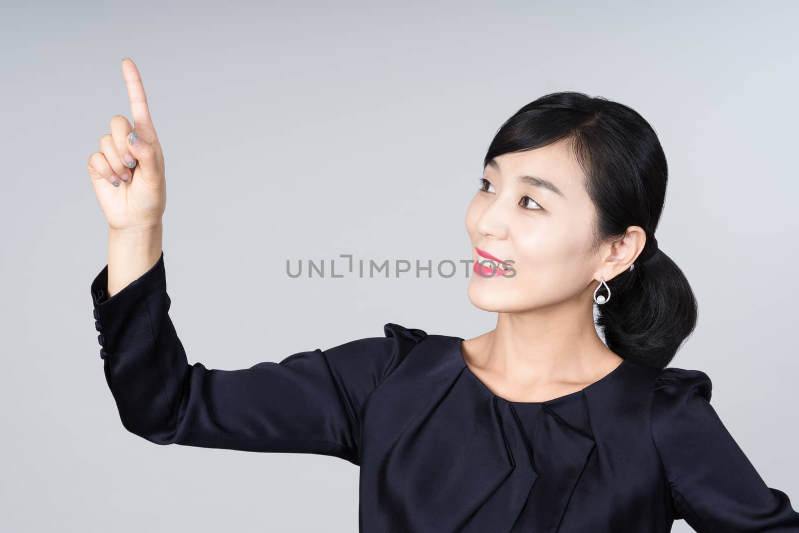 An attractive Asian woman grey background Studio images