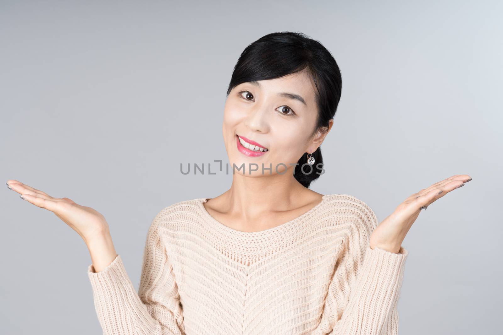 An attractive Asian woman grey background Studio images