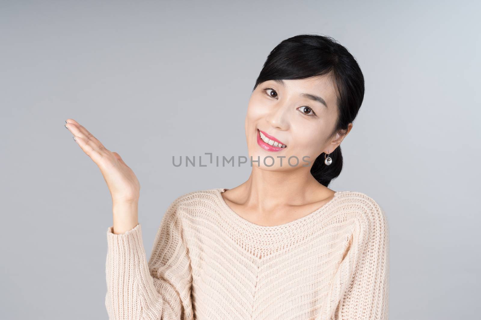 An attractive Asian woman grey background Studio images