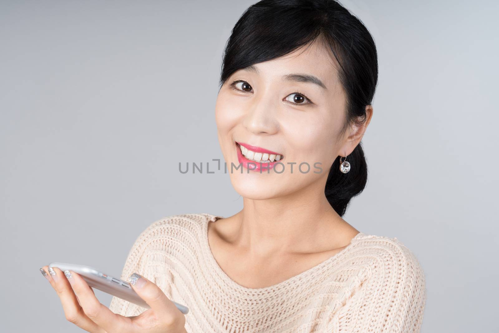 An attractive Asian woman grey background Studio images